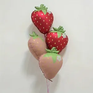 Matte strawberry shaped foil balloons in red and pink for birthday party decorations