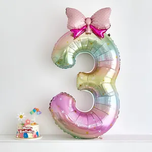 Rainbow gradient 40-inch number 3 balloon with star prints and pink bow for girl's birthday