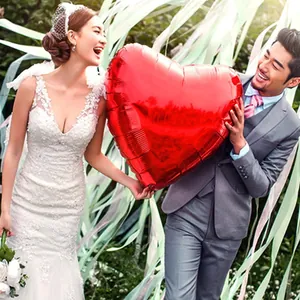 32-inch red heart foil balloon held by a bride and groom for romantic wedding decor