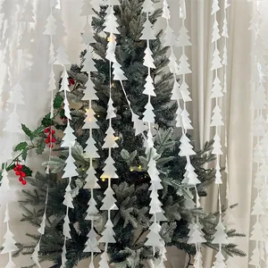 Detail of white star Christmas tree foil curtain decor with festive holiday background