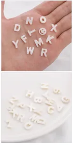 Macro detail of white freshwater shell letter beads for DIY jewelry making