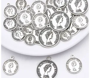 Macro view of silver coin pendants with Queen Elizabeth II relief for DIY jewelry making