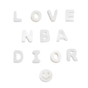 White pearlescent shell letter beads spelling LOVE for DIY jewelry and accessories