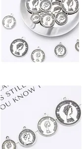 Detailed macro view of vintage silver coin charms with Queen Elizabeth profile for DIY jewelry