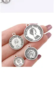 Macro detail of silver queen coin charms in four sizes for DIY jewelry making