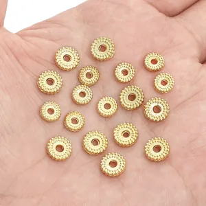 Vergulde tandwiel kralen voor DIY sieraden maken getoond in hand voor de grootte