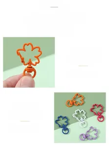 Macro detail of candy-colored alloy flower petal keychain hooks in multiple vibrant hues