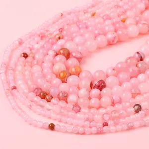 Macro detail of various pink round beads with natural textures for jewelry DIY making