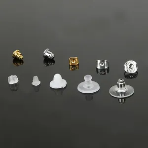 Assorted earring backs set with metal butterfly and silicone styles on black surface