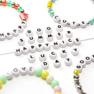Close-up of DIY colorful ceramic letter beads and alphabet bracelets for jewelry making