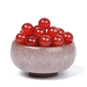 Red agate loose round beads for DIY jewelry making displayed in a ceramic bowl