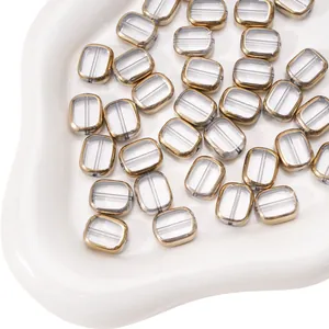 Macro view of rectangular transparent glass beads with gold edges for DIY jewelry making