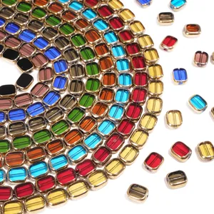 Colorful oval glass beads with gold trim for DIY jewelry making in a spiral layout