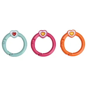 Close-up of heart-shaped spring O-rings in mint green, rose red, and vibrant orange