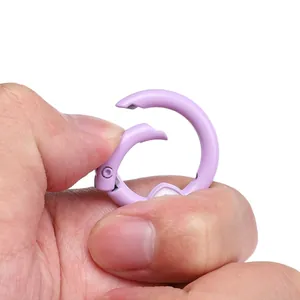 Detail view of a light purple round spring clasp showing the mechanical opening mechanism