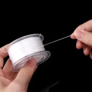 Strong white 0.8mm elastic crystal string roll for DIY jewelry making on black background
