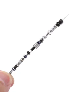 Macro view of dark glass beads and metallic spacers for DIY jewelry making