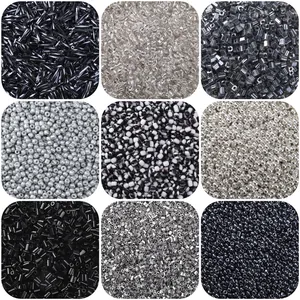 Macro view of assorted black glass beads in tube and round shapes for DIY jewelry