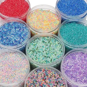 Detailed top view of assorted vibrant 2-4mm glass seed beads in transparent storage jars