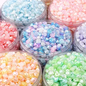 Macro shot of iridescent ABS pearl camellia flower beads for DIY jewelry making in jars