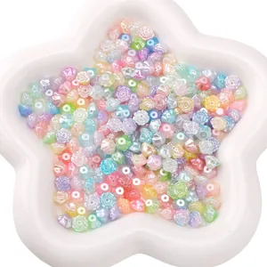 Macro shot of camellia flower-shaped macaron beads with pearlescent finish in a white tray
