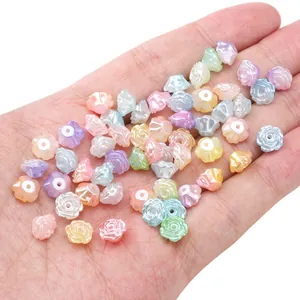 Macro shot of colorful pearlescent camellia flower beads held in hand for DIY jewelry