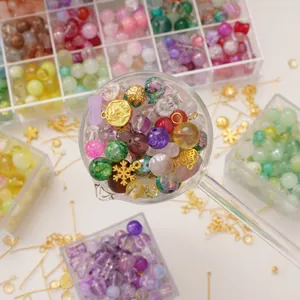 DIY jewelry making kit with colorful glass beads and gold charms in a clear storage box