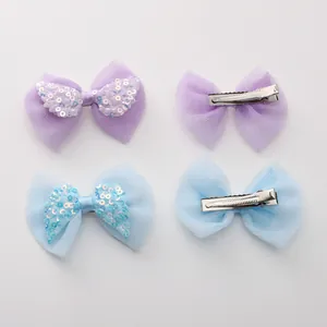 Detailed view of mesh bow hair clips with sequins and metal alligator clips for DIY