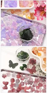 Detail view of assorted frosted acrylic beads with floral and bow shapes for DIY jewelry