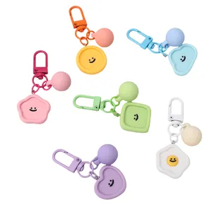 Detailed view of macaroon-colored resin smiley keychains in flower and heart shapes