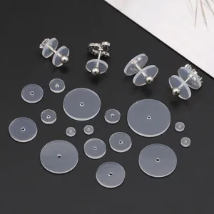 Macro shot of assorted transparent silicone earring stabilizers and silver stud accessories