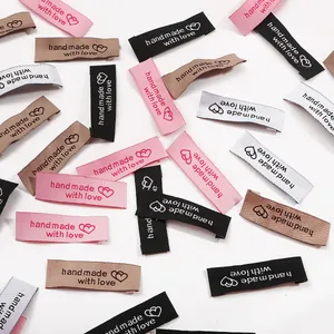 Detail of colorful woven garment labels featuring Handmade with Love text and hearts