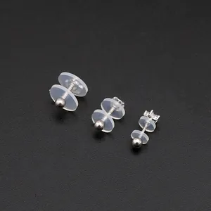Macro shot of silver earring studs with silicone disc pads for DIY jewelry making