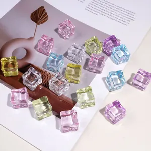 Macro shot of 18mm colorful acrylic faux ice cubes scattered on a white magazine page