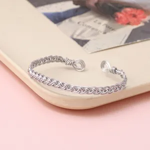 Detailed view of silver braided wire cuff bracelet featuring handcrafted twisted texture