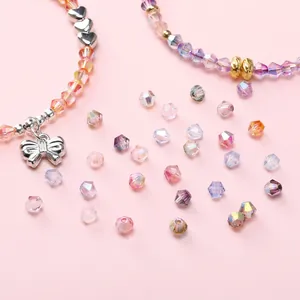 Macro shot of colorful faceted crystal beads with silver heart and bow charm accessories