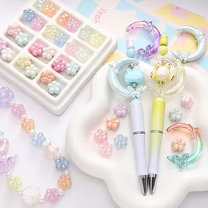 DIY colorful acrylic bead kit with pastel ballpoint pens and flower beads in storage box