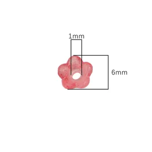 Macro detail of a 6mm pink acrylic flower bead with 1mm hole for DIY jewelry making