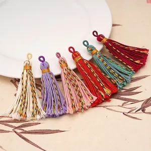 Detail of colorful Tibetan cotton tassels with gold thread neck and mixed fibers
