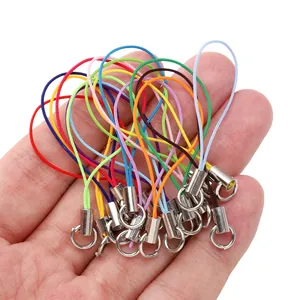 Macro shot of colorful woven polyester lanyards with silver metal spring clasps in hand