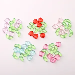 Macro shot of colorful acrylic tulip and green leaf beads for DIY jewelry making