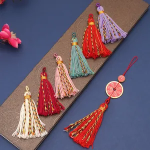 Colorful Tibetan cotton tassel pendants with golden wrap and traditional lucky charm details