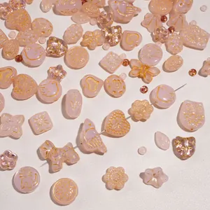 DIY glass beads set with pink butterfly and animal shapes featuring gold embossed designs