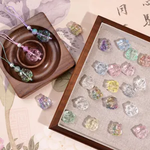 Detailed macro view of colorful glass cat-shaped charms for DIY jewelry and accessories