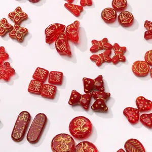 Red Czech glass beads with gold floral patterns in flower and heart shapes for DIY jewelry