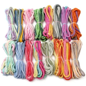 Close-up of colorful 3-strand braided cotton cords for DIY jewelry and crafts making