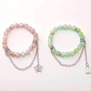 Braccialetti di perline coordinati con ciondoli a cuore e farfalla in tonalità pastello