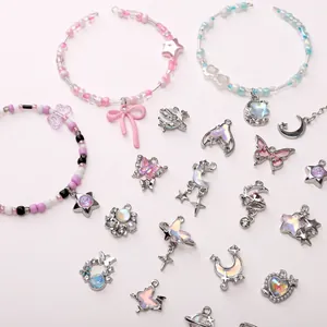 Flat lay of Y2K style butterfly, moon, and pearl charms for DIY jewelry making