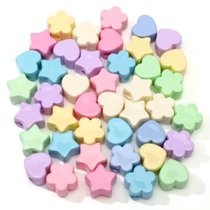 Macro shot of colorful acrylic beads in star heart and flower shapes for DIY jewelry