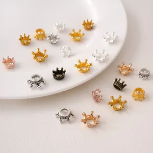 Detailed macro view of 3D alloy crown beads in gold and silver for DIY jewelry making